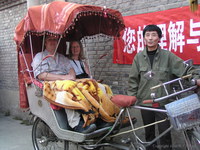 Margaret and Alan in a rickshaw in a Beijing hutong