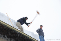 Knocking ice of the roof opposite the Alpina hotel