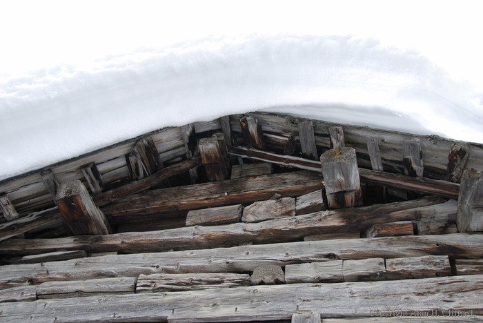 Snow on the roof of a wooden building