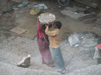 Women’s lib. in action:  carrying gravel