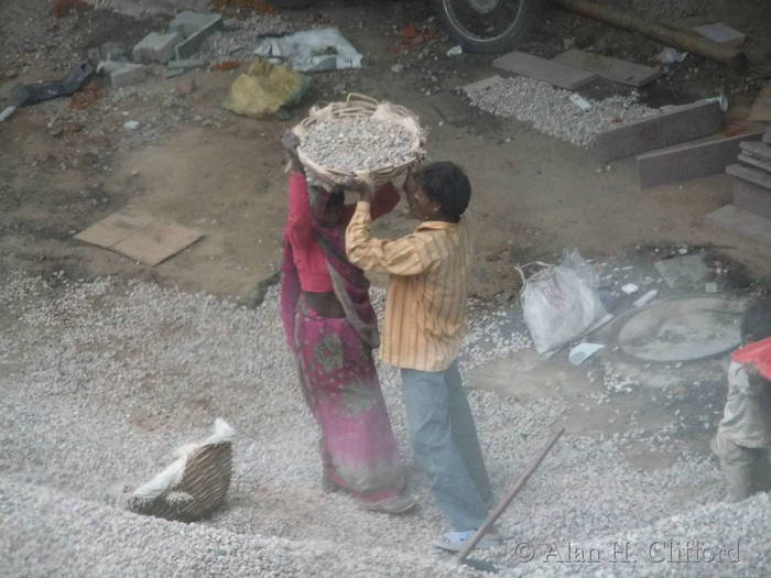 Women’s lib. in action:  carrying gravel