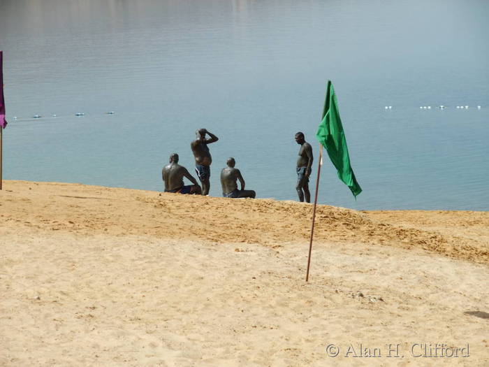 Muddy men at the Dead Sea