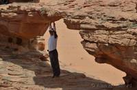 Japanese tourist under a rock bridge